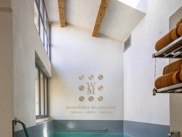 Interior of a property with swimming pool and natural light in L'Isle-sur-la-Sorgue.