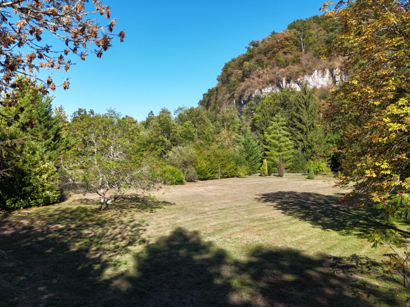 View of a wooded park on the banks of the Ain river in Neuville-sur-Ain.