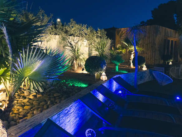 Contemporary villa with swimming pool and garden in Narbonne, night lighting.