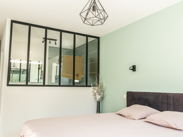 Bedroom in a contemporary villa in Narbonne with modern decor and natural light.