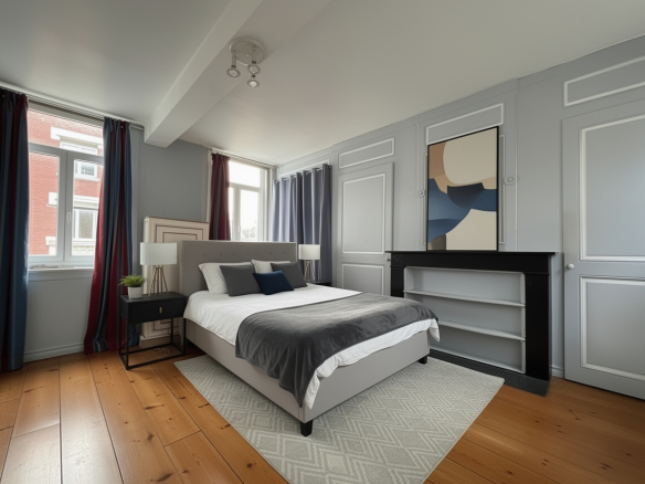 Bedroom in a mansion in Lille, with bed, windows and modern decor.