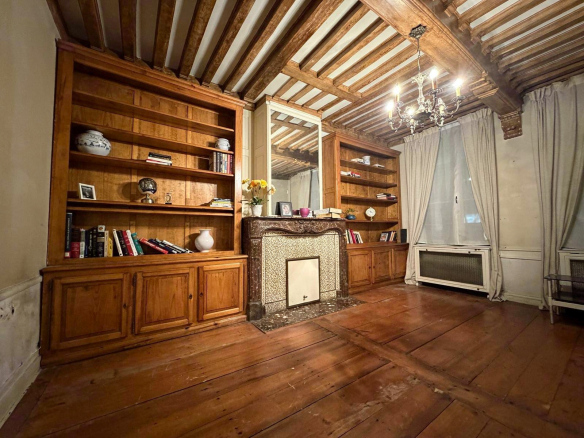 Interior of a mansion in Lille with wooden shelves and antique parquet flooring.