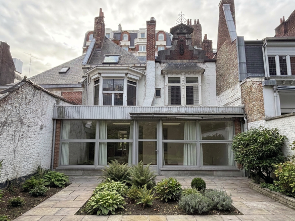 Manor house in Old Lille with garden and veranda, 19th century architecture.