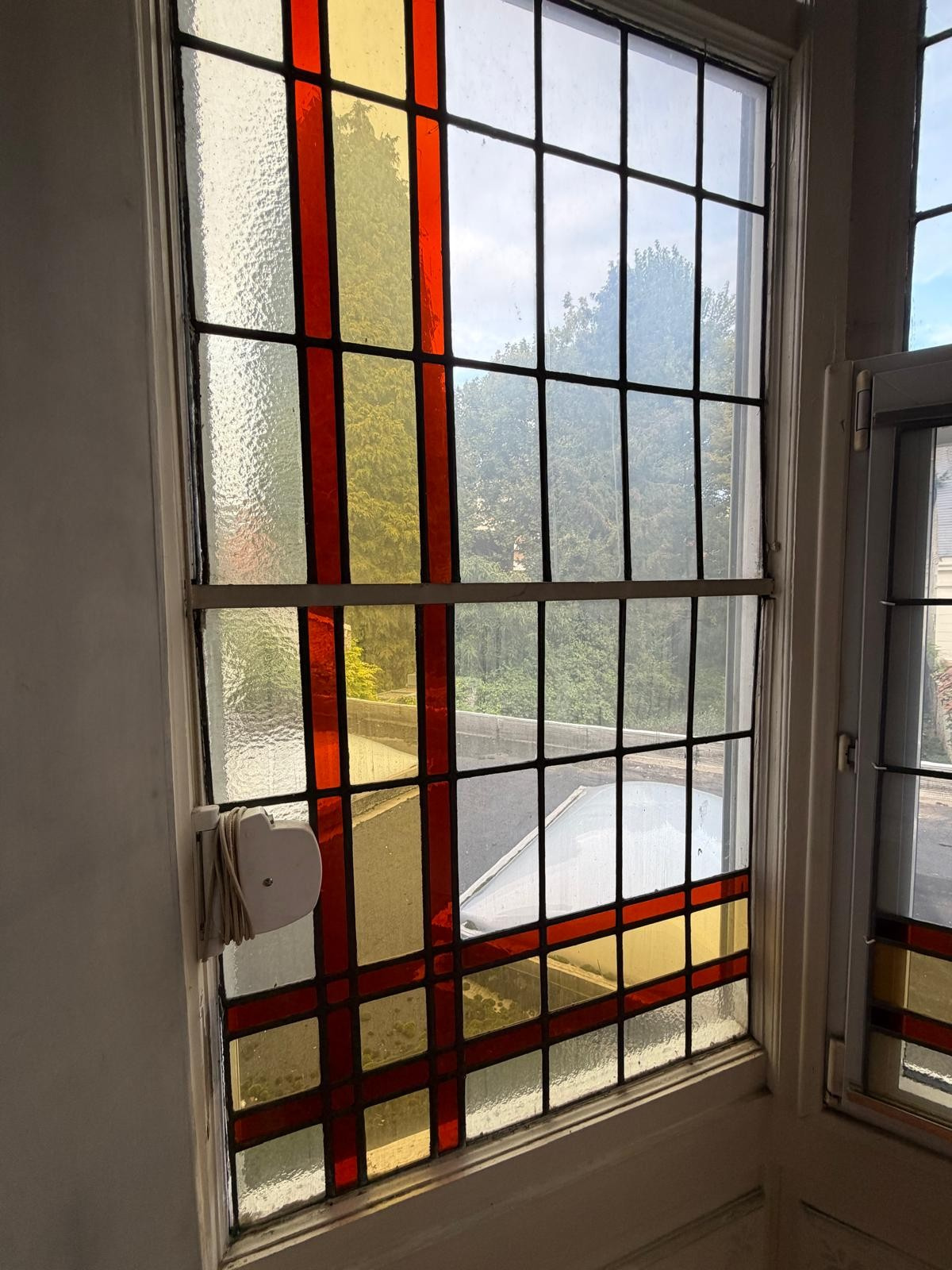Stained glass window in a manor house Colourful stained glass window in a mansion in Lille, with a view of the outside.