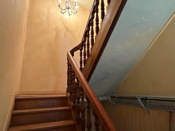 Wooden staircase leading to the upper floor of a mansion in old Lille.