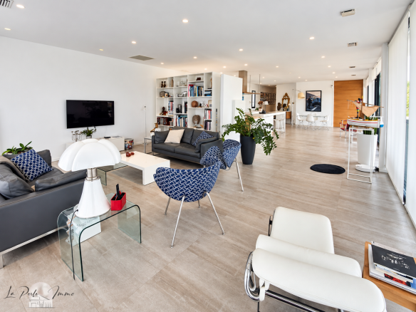 Intérieur d'une villa contemporaine avec salon spacieux et cuisine ouverte.