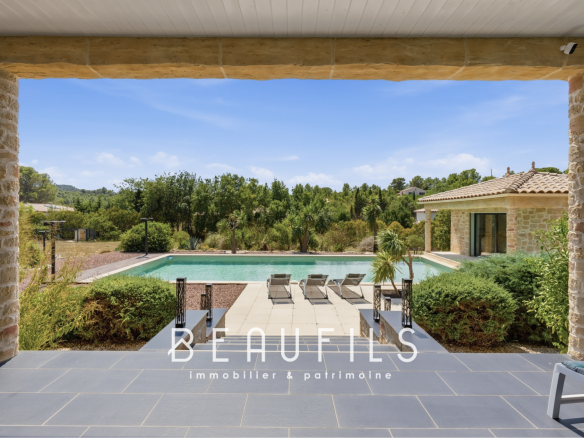 View of a property with swimming pool and landscaped grounds, located near Narbonne.
