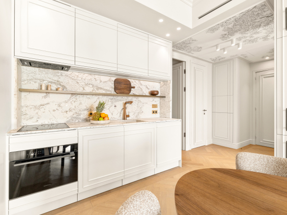 Modern kitchen with marble worktop and wooden elements in a renovated apartment in Nice.