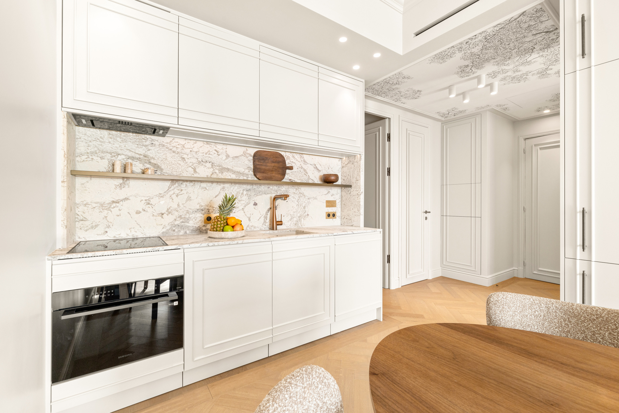 Kitchen of a renovated apartment in Nice Modern kitchen with marble worktop and wooden elements in a renovated apartment in Nice.