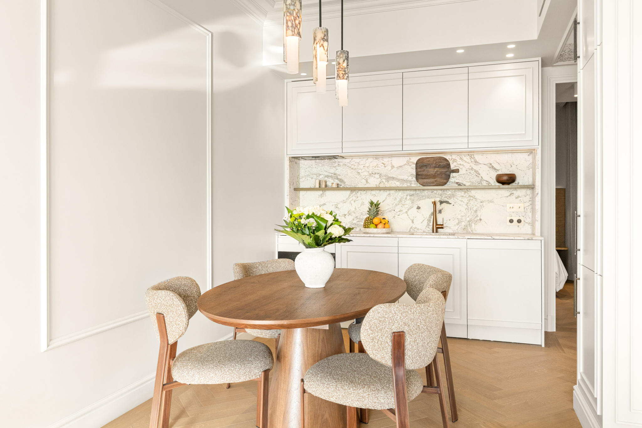 Interior of an apartment in Nice Interior of a renovated apartment with a round table and chairs, overlooking a modern kitchen.