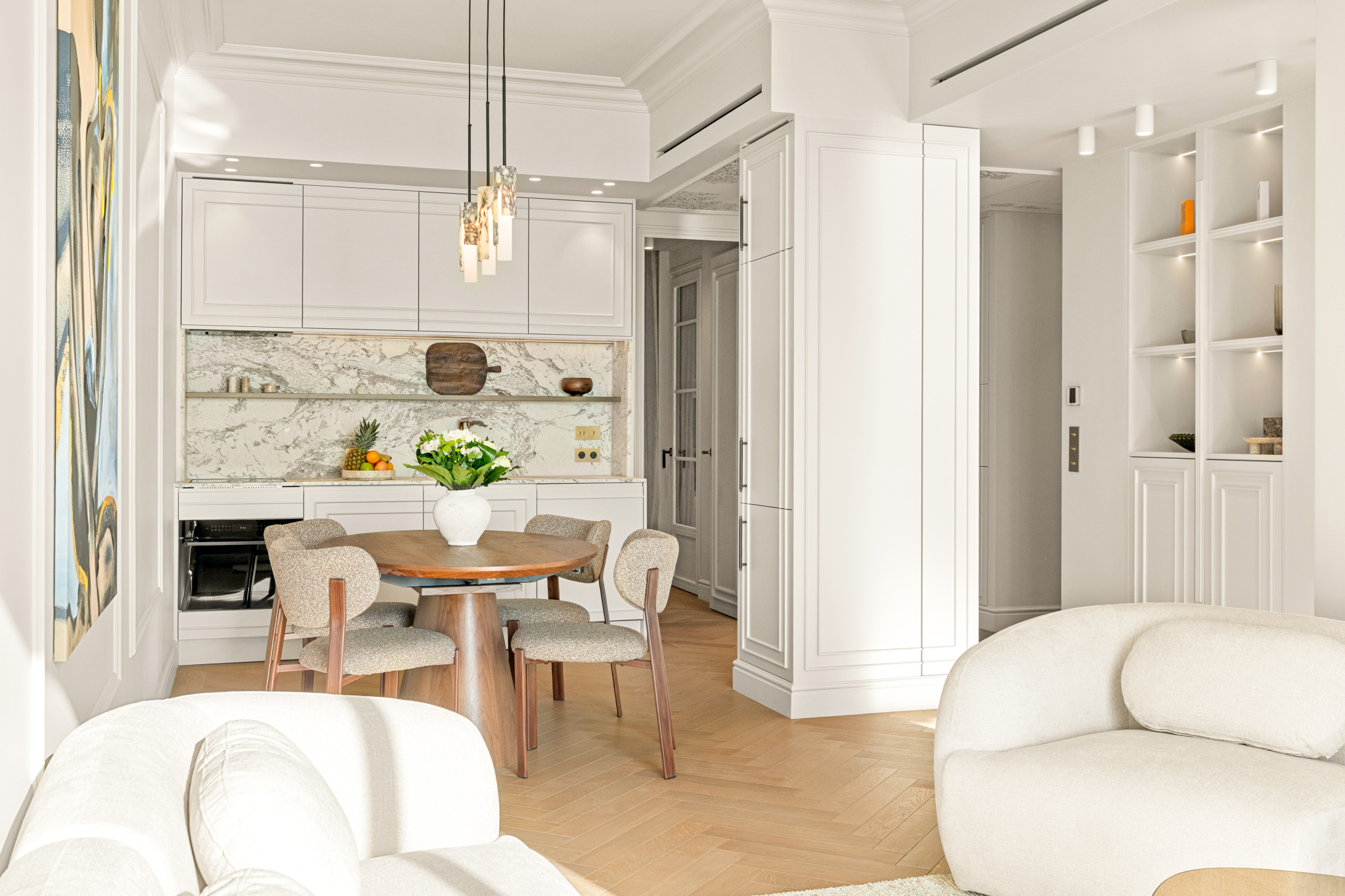 Renovated apartment in Nice with sea view Interior of a renovated apartment with sea views in Nice, including a living room and a modern kitchen.