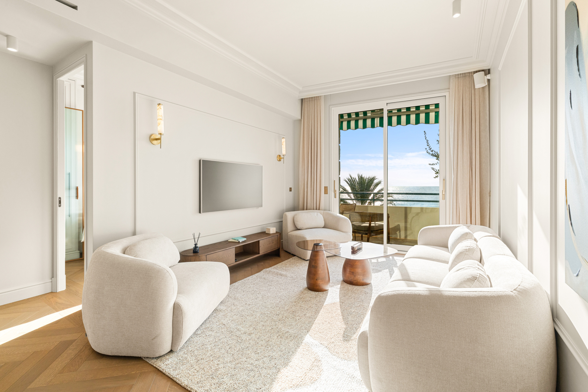Living room with a view of the Mediterranean Modern living room with sea view, contemporary furniture and large windows in Nice