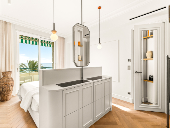 Chambre d'un appartement rénové avec vue sur la mer à Nice, fenêtres ouvertes sur la Méditerranée.