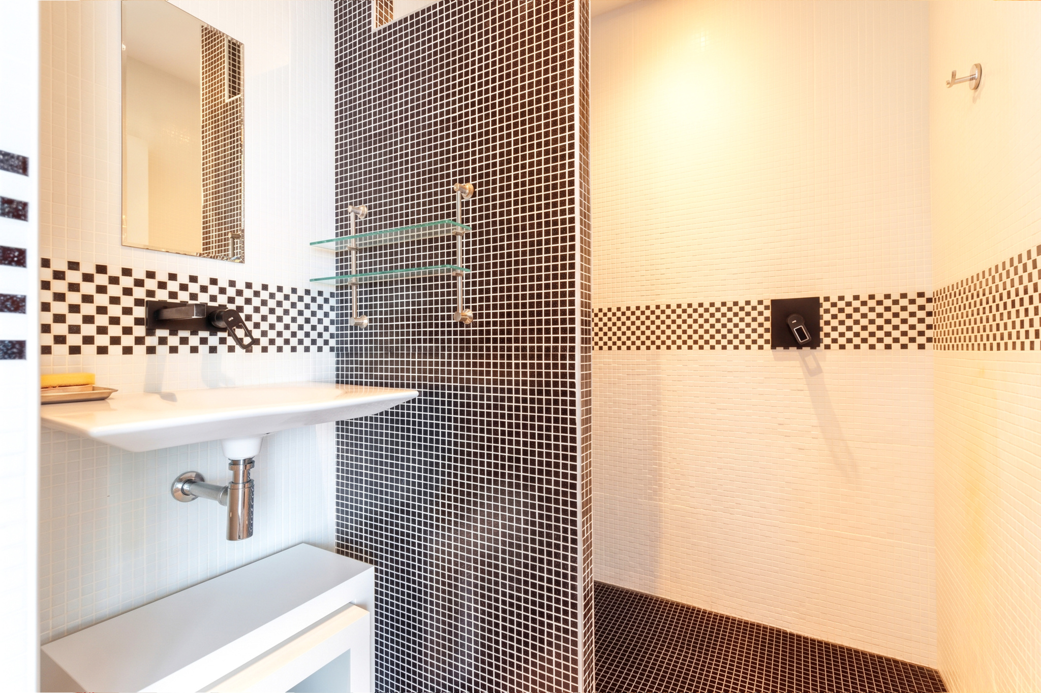 Salle de bain contemporaine Salle de bain moderne avec douche et lavabo, carrelage noir et blanc.