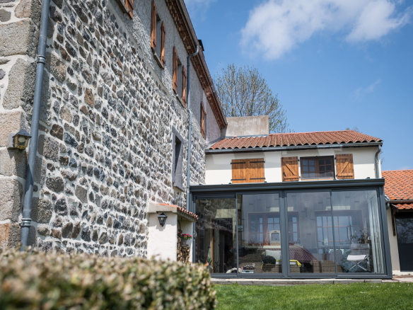 Renovated old stone farmhouse with veranda, located in Olloix, Auvergne Volcanoes Regional Natural Park.