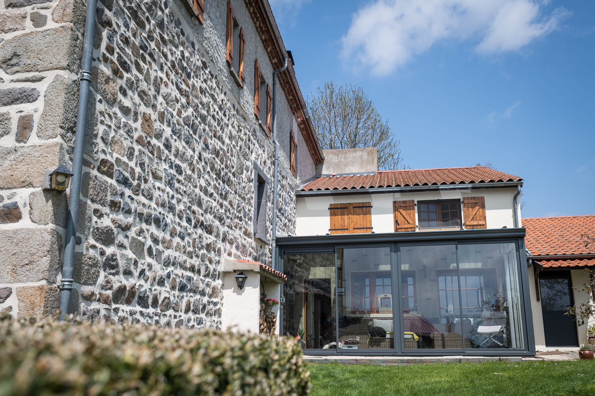 Renovated old stone farmhouse with veranda, located in Olloix, Auvergne Volcanoes Regional Natural Park.