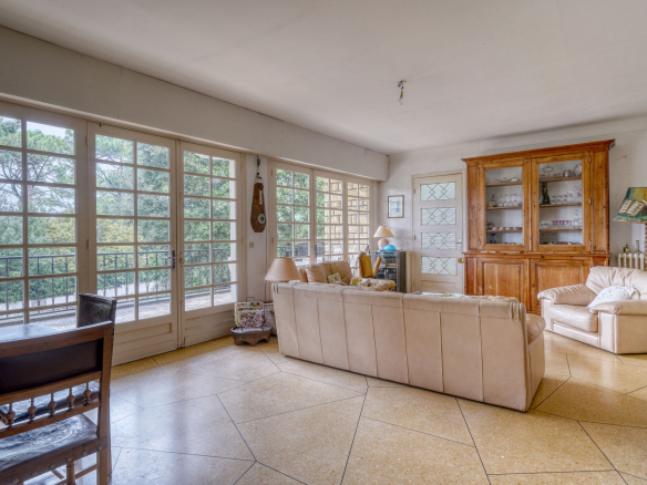Interior of a traditional house with a bright living room and wooden furniture.