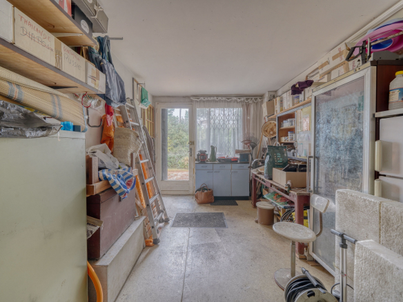 Interior of a traditional house to be renovated, with furniture and various objects.