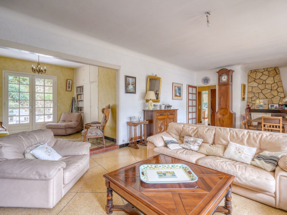 Interior of a traditional house with living room, dining room and fireplace.
