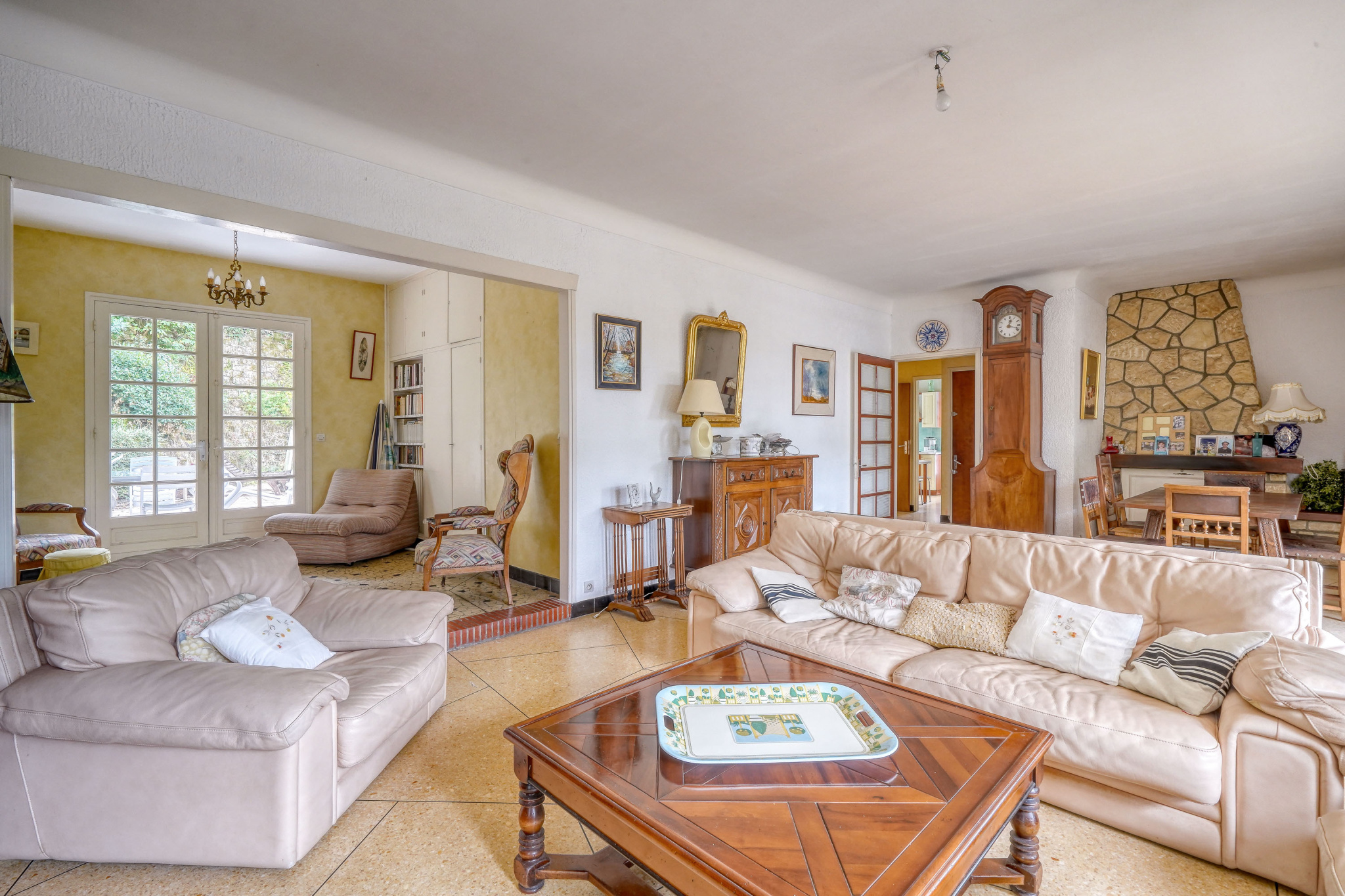Interior of a house in need of renovation Interior of a traditional house with living room, dining room and fireplace.