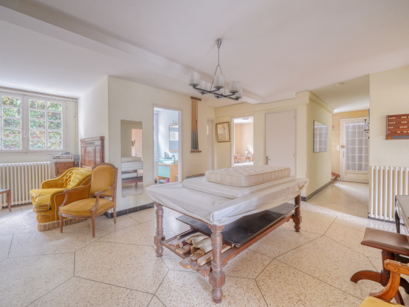 Interior of a traditional house to be renovated, with living room and antique furniture.