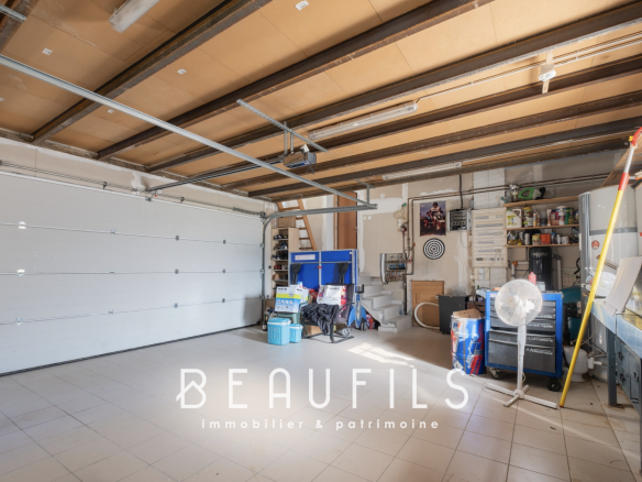 Spacious garage with natural light and storage equipment.