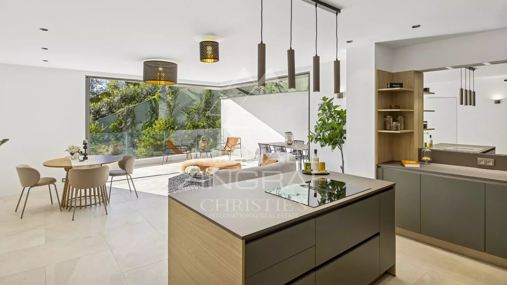 Intérieur d'un appartement moderne avec cuisine ouverte et salle à manger, baigné de lumière naturelle.