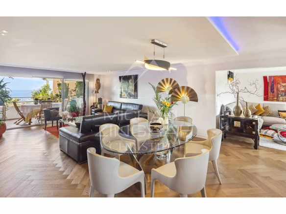 Intérieur d'un appartement rénové avec vue sur la mer et le mobilier moderne.