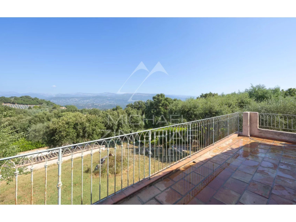Unobstructed view of the hills from a terrace with balustrade in Mandelieu-la-Napoule.