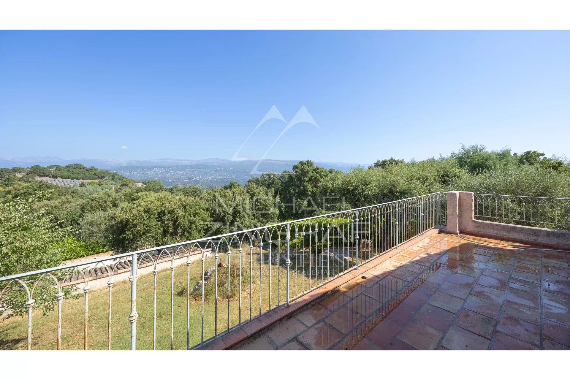 Unobstructed view of the hills from a terrace with balustrade in Mandelieu-la-Napoule.