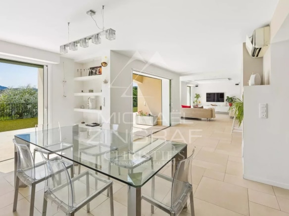 Interior of a contemporary villa with dining room and view of the outside in Mandelieu-la-Napoule.