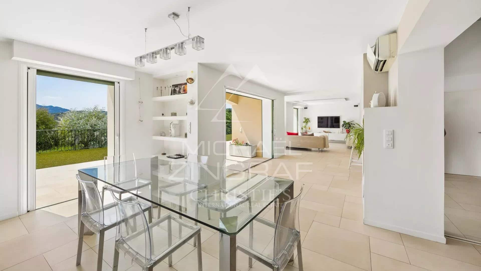 Interior of a contemporary villa Interior of a contemporary villa with dining room and view of the outside in Mandelieu-la-Napoule.