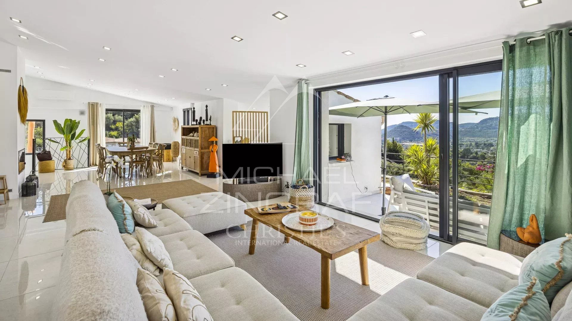 Interior of a renovated modern villa with panoramic views, bright living room and contemporary furniture.