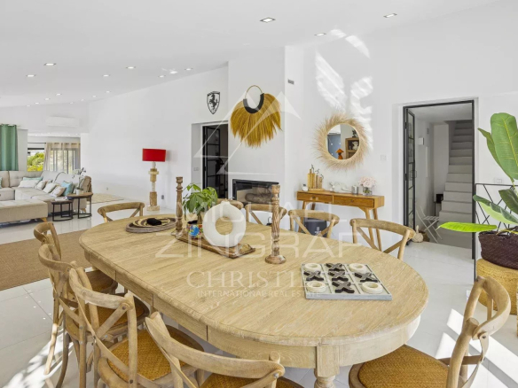 Interior of a renovated modern villa with a bright dining room and living room in Mandelieu-la-Napoule.