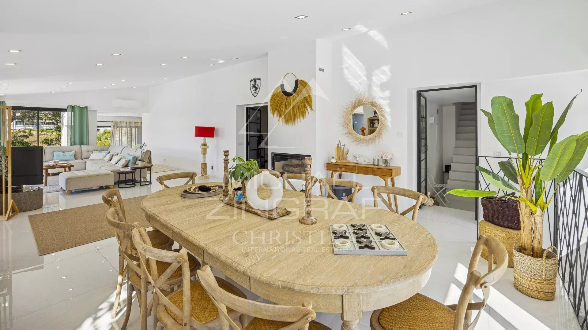 Interior of a renovated modern villa with a bright dining room and living room in Mandelieu-la-Napoule.