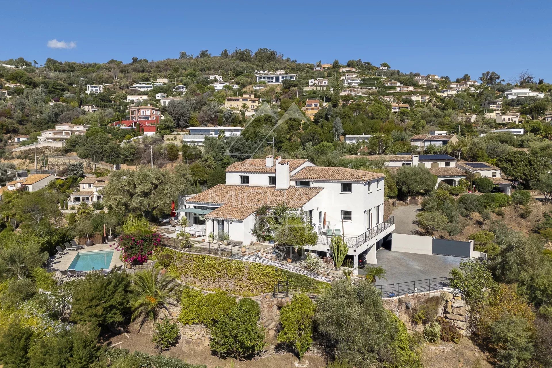 Aerial view of a renovated modern villa in Mandelieu-la-Napoule with swimming pool and garden.