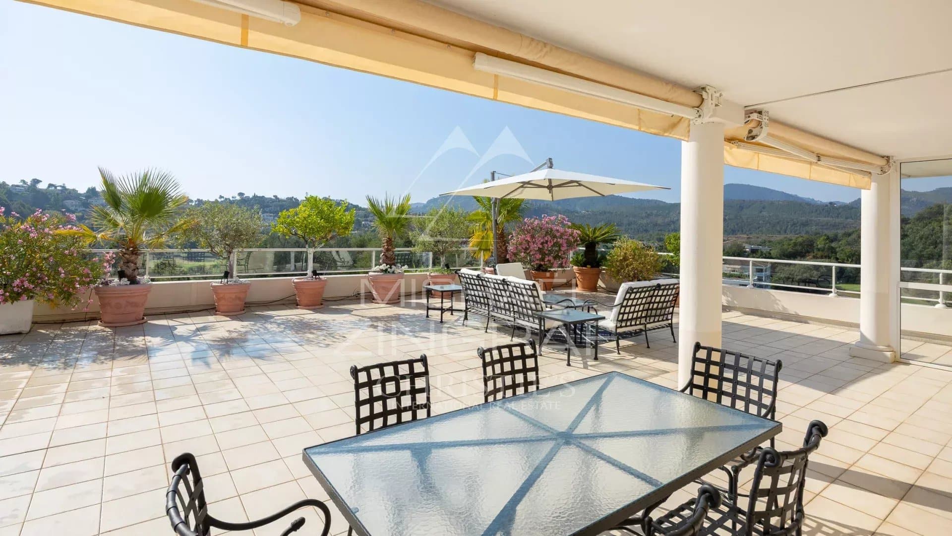 Spacious terrace of a top floor apartment overlooking the Barbossi golf course in Mandelieu-la-Napoule.