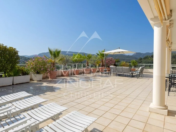 Spacious terrace of a top floor apartment with views of the golf course and mountains in Mandelieu-la-Napoule.
