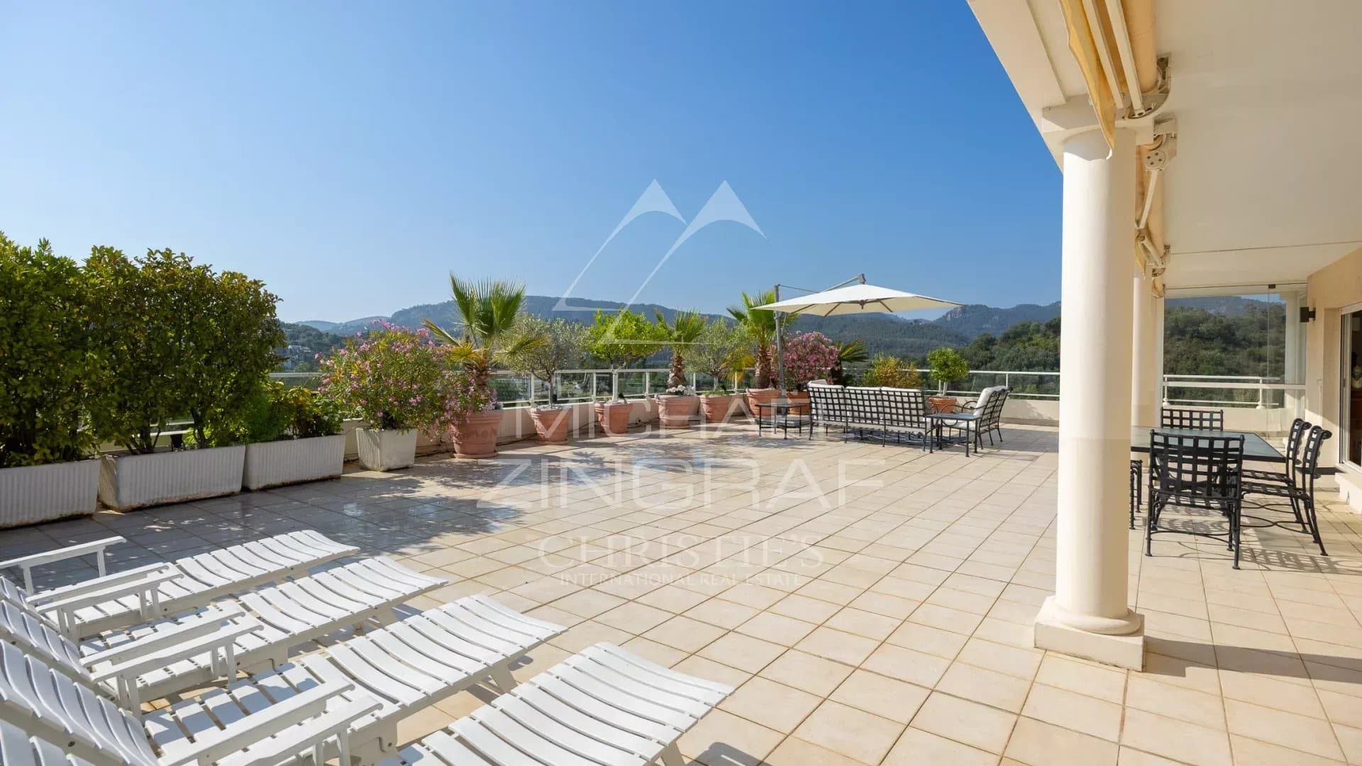 Spacious terrace of a top floor apartment with views of the golf course and mountains in Mandelieu-la-Napoule.