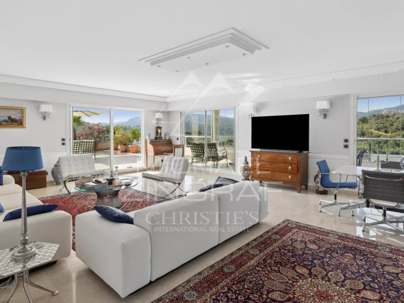 Spacious and bright living room of a top-floor apartment with views of nature.