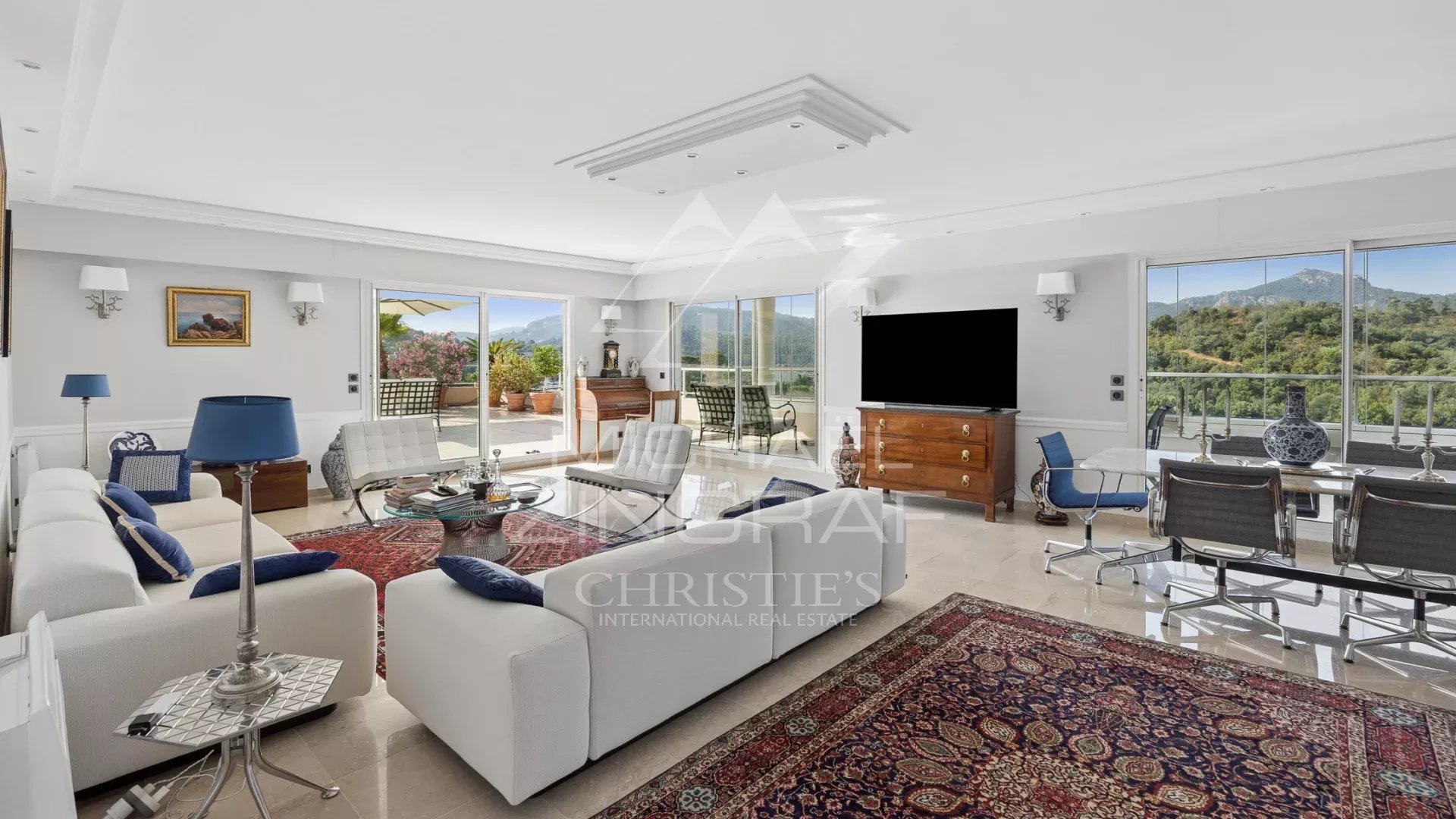 Spacious and bright living room of a top-floor apartment with views of nature.