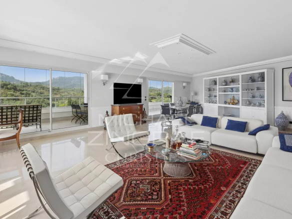 Spacious living room in a top-floor apartment with golf course views, contemporary decor and elegant furnishings.