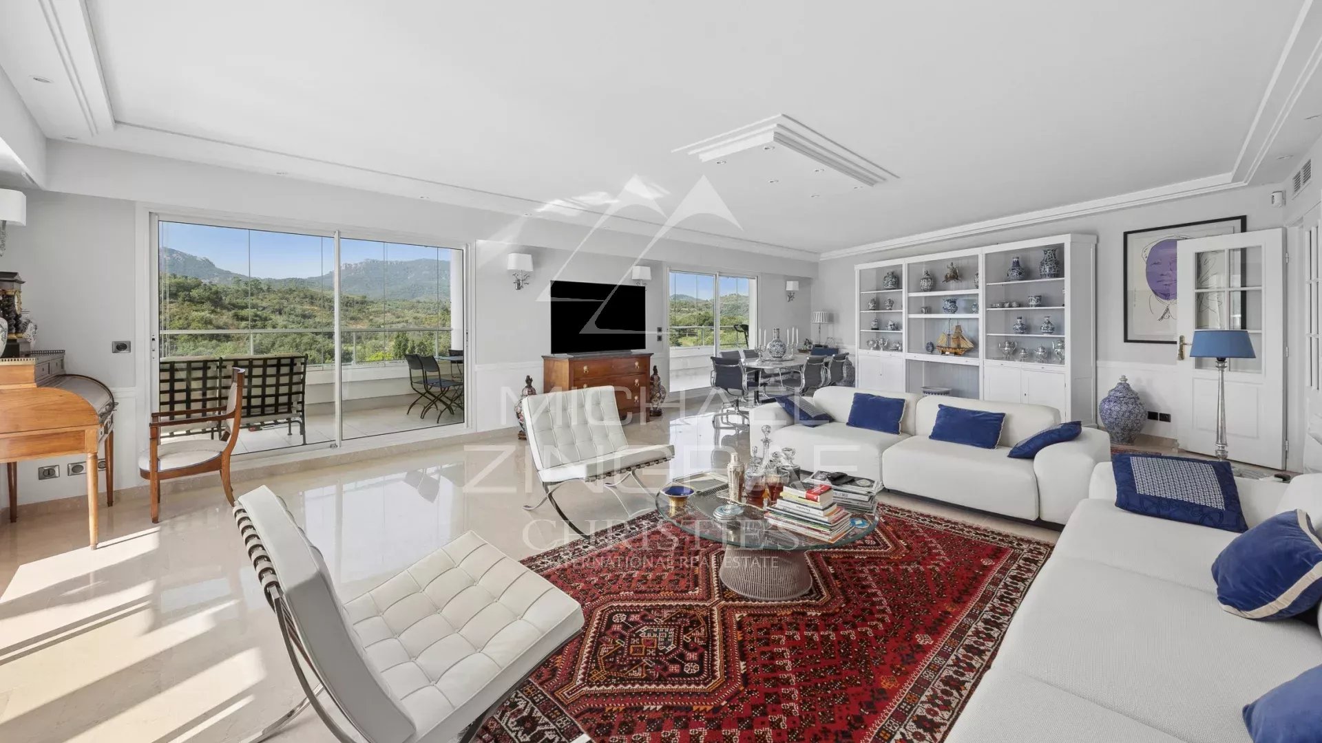 Spacious living room in a top-floor apartment with golf course views, contemporary decor and elegant furnishings.