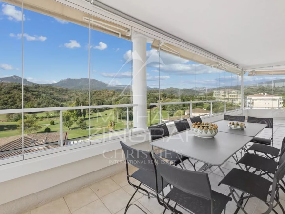 Terrace of a top-floor apartment with views of the golf course and surrounding hills in Mandelieu-la-Napoule.