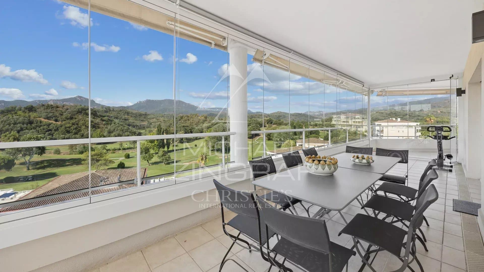 Terrace of a top-floor apartment with views of the golf course and surrounding hills in Mandelieu-la-Napoule.