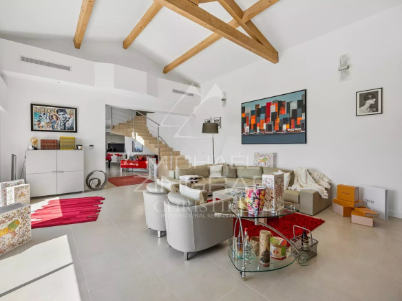 Intérieur d'une villa moderne avec salon lumineux et décoration contemporaine.