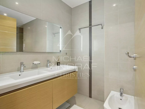 Modern bathroom with wooden furniture, mirror and shower.