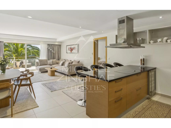Interior of a contemporary apartment with open kitchen and bright living room in Théoule-sur-Mer.