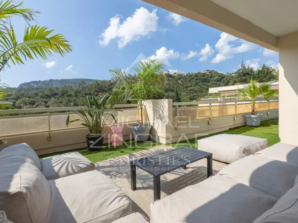 Terrasse d'un appartement avec vue sur la nature, mobilier de jardin confortable.