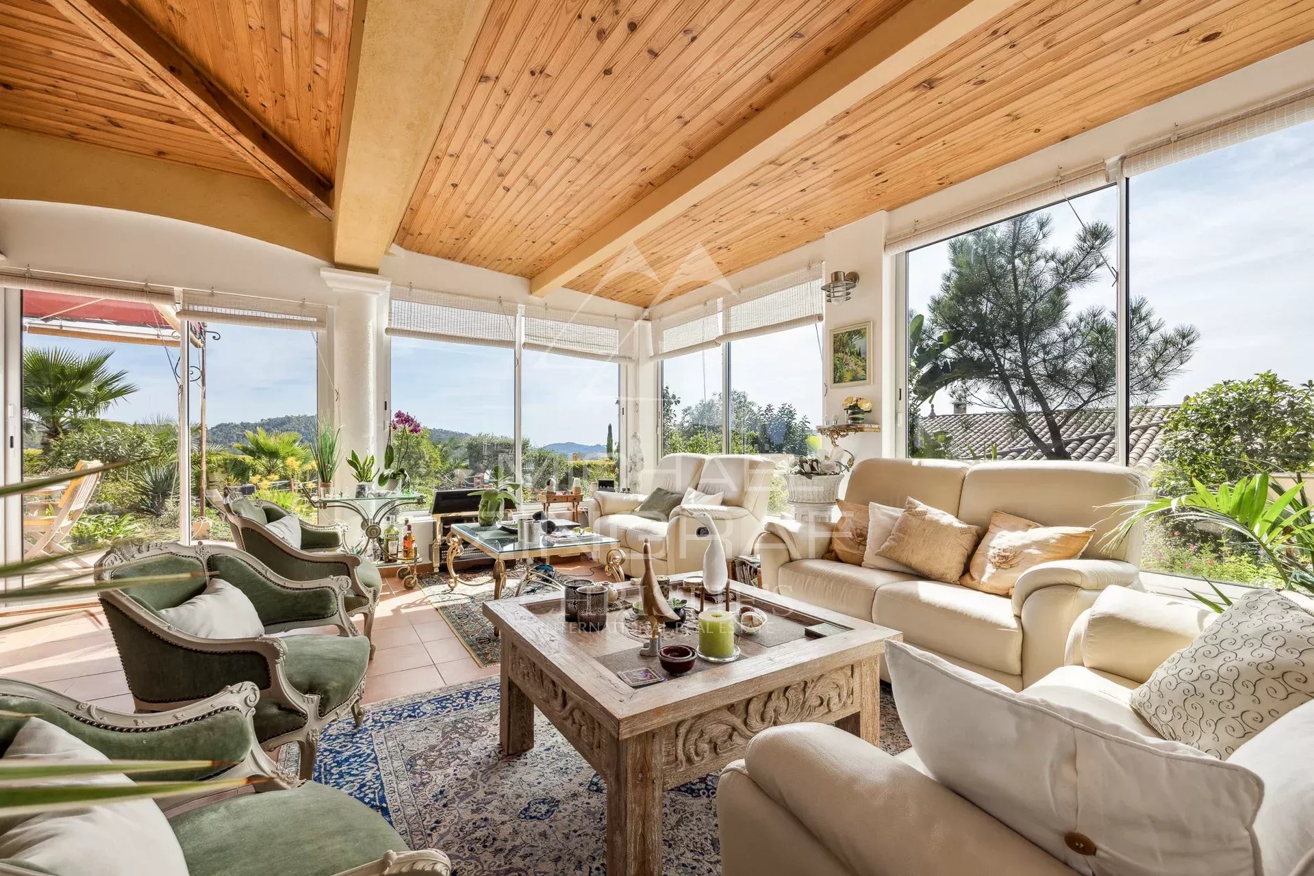 Living room of a Provençal villa in Tanneron Interior of a Provençal villa with a bright living room and a view of the garden.